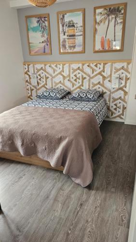 un lit avec une tête de lit en bois dans une chambre dans l'établissement Le 