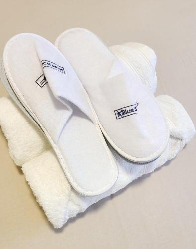 a pair of white sandals sitting on top of a towel at Room For Rent in Antwerpen in Antwerp