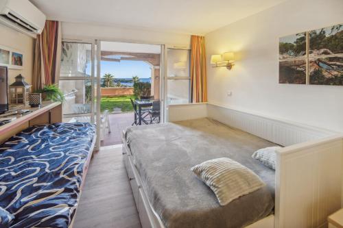 une chambre avec un lit et un balcon dans l'établissement Cap Estérel Magnifique vue mer avec parking et piscine, à Saint-Raphaël