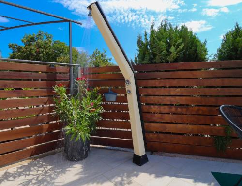 a fence with a gate and a plant at Villa Salvia Mare in Bilice