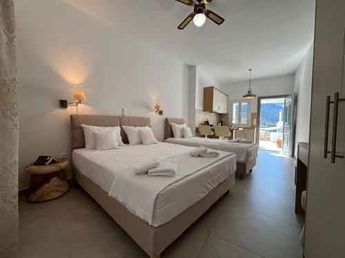 a bedroom with two beds and a living room at Margarita Karidi in Apollonia