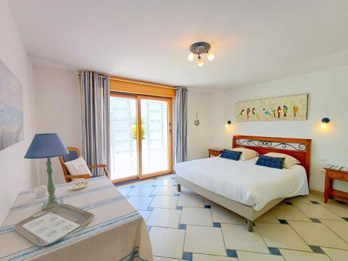 a bedroom with a bed and a table with a lamp at Gite de Kerantum in Mahalon