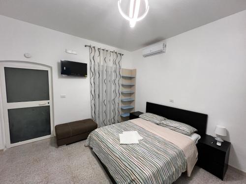 a bedroom with a bed and a television in it at Manzoni Holiday 185 in Bari