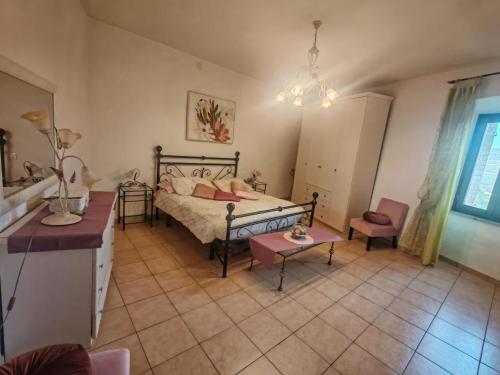a bedroom with a bed and a table and a chair at Gabri's Home in Spello