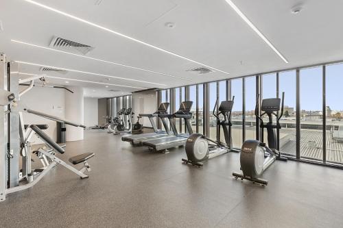 a gym with treadmills and cardio machines in a building at Gorgeous High-Rise Unit with Sky Bar Pool and Gym in Melbourne