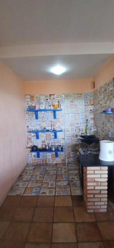 a room with a wall full of shelves of dishes at Flat Casa Taiba 2002 in São Gonçalo do Amarante