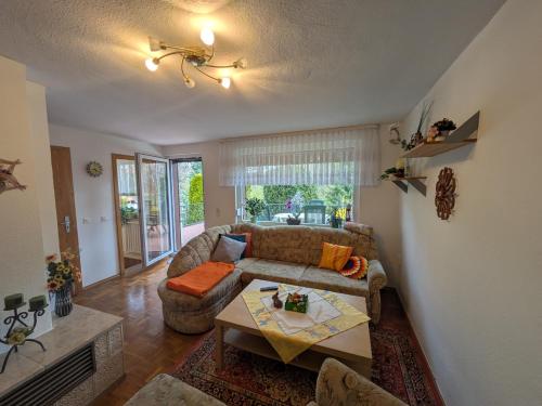 a living room with a couch and a table at Ferienhaus Am Freibad in Bad Berka
