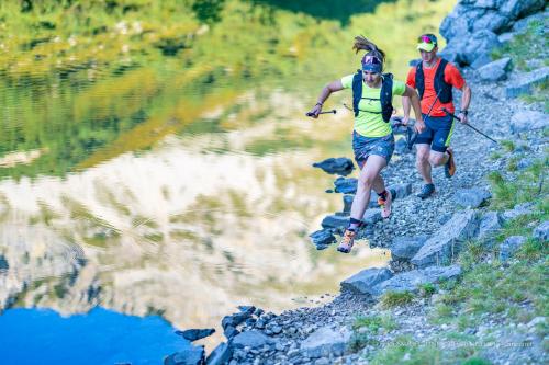 two people running on a mountain trail near a body of water at Ferienwohnung Ferienglück in Krün