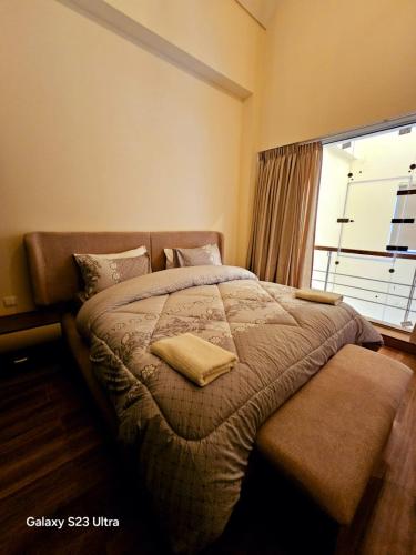 a bedroom with a large bed with a window at C32 Samarah Resort LOFT apartment in Sowayma