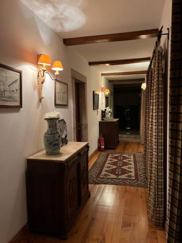 a living room with a vase on a wooden table at Casa De Canilhas in Mesão Frio