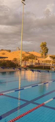 a swimming pool with a light pole in the middle of it at Toodyay Upon Avon Guest House and Gallery in Toodyay