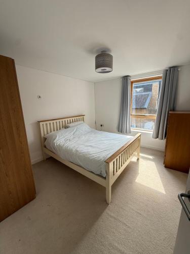 a bedroom with a bed in a room with a window at Spacious 4 Bedroom Townhouse in Essex in Burnt Mill