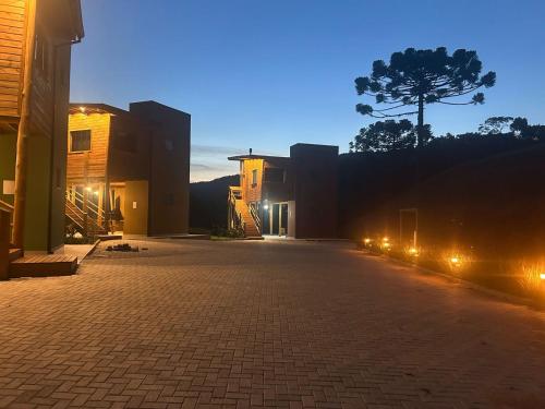 an empty street at night with lights on it at Cabana Bariloche - Busch Camping in Rancho Queimado