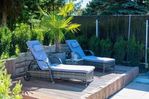 two chairs and a ottoman sitting on a patio at Pension Zur Krone in Martinfeld