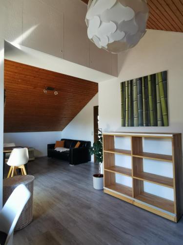 a living room with a couch and a lamp at Ferienwohnung Magnolie in Langenargen in Langenargen