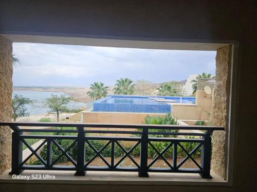 a window with a view of a building and water at E01 Samarah Resort One Bedroom apartment in Sowayma