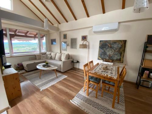 a living room with a table and a couch at Romantic mountain cabin 10km to Skopje downtown in Skopje