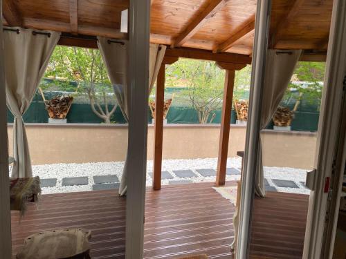 an open door to a porch with a wooden floor at Romantic mountain cabin 10km to Skopje downtown in Skopje