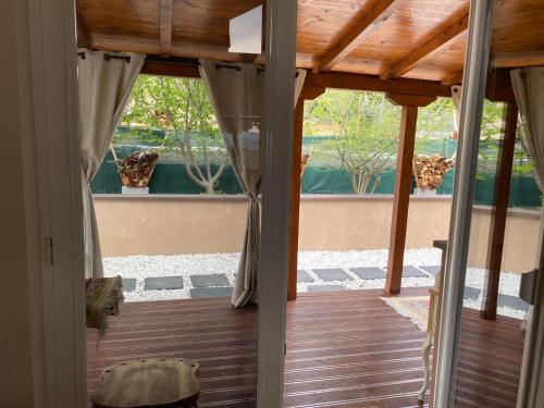 an open door to a patio with a wooden floor at Romantic mountain cabin 10km to Skopje downtown in Skopje