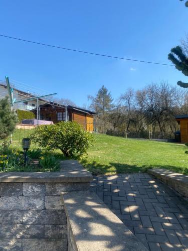 a brick walkway in a yard with a grass field at Familie Moisil in Daun