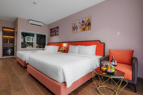 a large bedroom with a large bed and a couch at Salute Saigon Hotel and Spa in Ho Chi Minh City