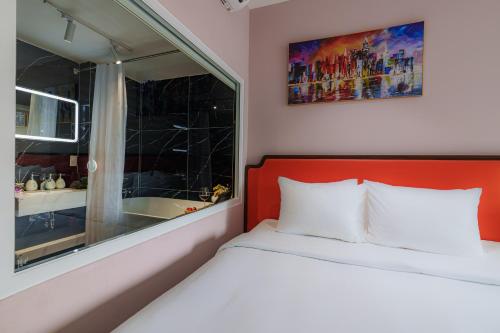 a small bedroom with a bed and a window at Salute Saigon Hotel and Spa in Ho Chi Minh City
