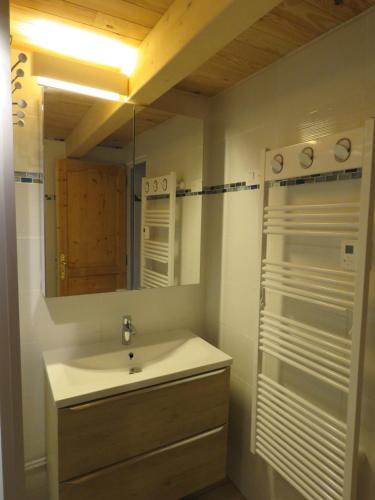 a bathroom with a sink and a mirror at Chez Maria in Corbel