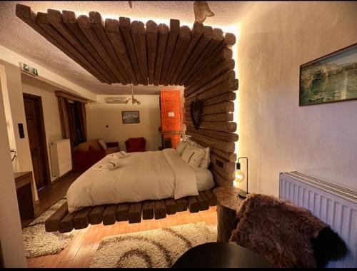 a bedroom with a large bed with a wooden ceiling at 4 MOUNTAIN HILLS in Méga Khoríon