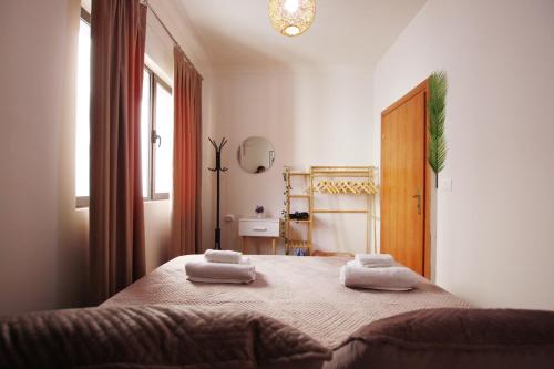 a bedroom with a bed with two towels on it at Villa Reve de Tirana in Tirana