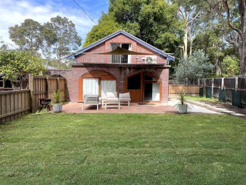 a brick house with a patio and a yard at Southside Getaway in Margaret River Town