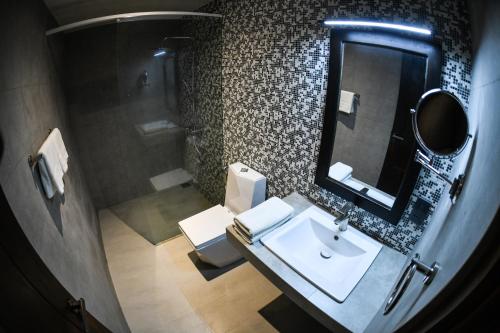 a bathroom with a sink and a mirror at Hiriketiya Beach Resort in Hiriketiya