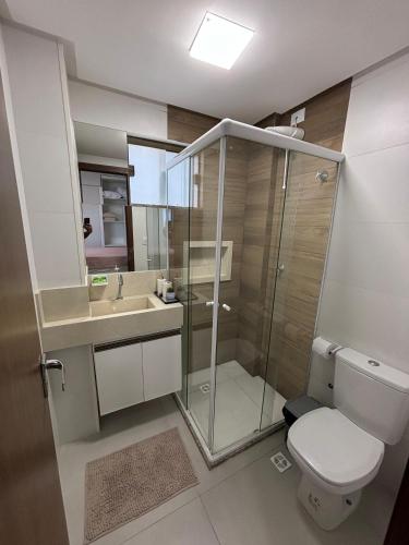 a bathroom with a shower and a toilet and a sink at villa privilege ap 01 in Marau