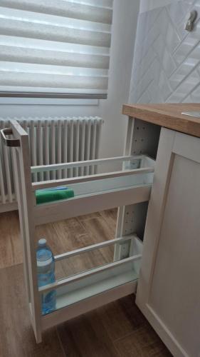 a shelf in a kitchen with a table and a radiator at Canaletto apartment con parcheggio in Dolo