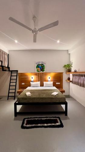 a bedroom with a bed with two lights on it at GAIA ELLA Ecolodge and Yoga Centre in Ella
