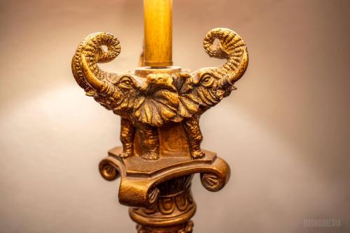 a gold candle holder with a candle stick at Step Back in Time Charming Victorian with Modern Amenities in Homestead