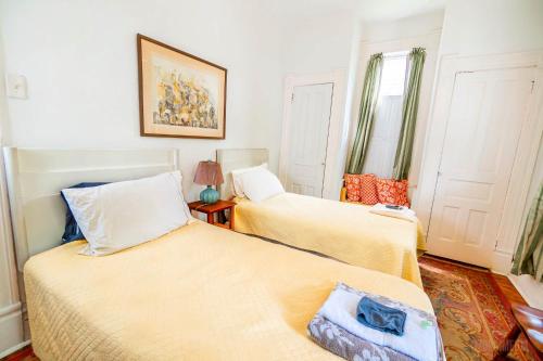 a bedroom with two beds and a window at Step Back in Time Charming Victorian with Modern Amenities in Homestead