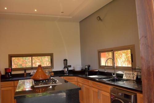 a kitchen with a sink and a stove at Villa Essalam Marrakech in Marrakech
