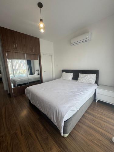 a bedroom with a large bed and a mirror at Caesar Resort & SPA - Apartment with 2 Bedroom - Aurelius in Saint Yeorgios