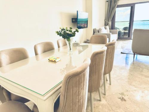 a dining room with a table and chairs at ALEX HOMES - Gleem Luxury Apartments with Direct Sea View in Alexandria