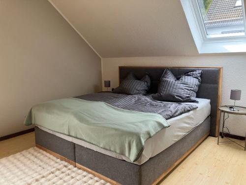 a bedroom with a large bed in a attic at Ferienhaus am Mühlenberg in Schleiden