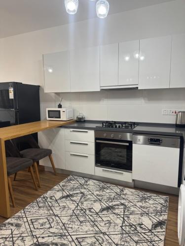 a kitchen with white cabinets and a stove at Caesar Resort & SPA - Apartment with 2 Bedroom - Aurelius in Saint Yeorgios
