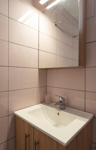 a bathroom with a white sink and a mirror at Bella Vista in Nydri