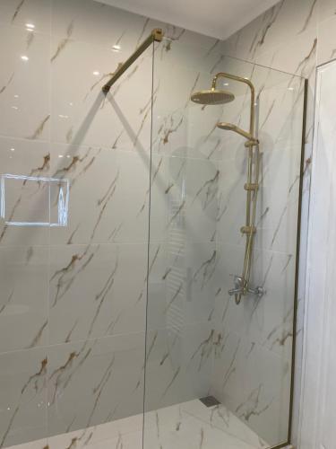 a bathroom with a shower with a glass door at Anastasias Holiday House in Stavros