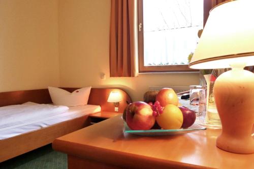a hotel room with a table with fruit on it at Landhotel Dresden in Dresden