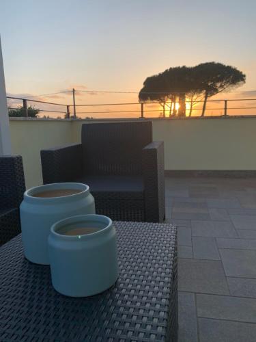 two blue pots sitting on a bench with the sunset at Domus Mellis in Velletri