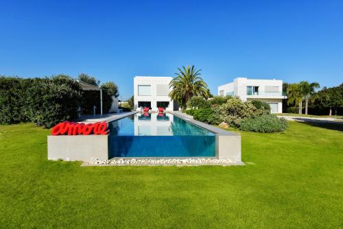 a swimming pool in the middle of a grass field at Villa VINNER - Monopoli in Monopoli