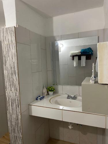 a bathroom with a sink and a mirror at Playa Paraiso en Magante in La Yagua