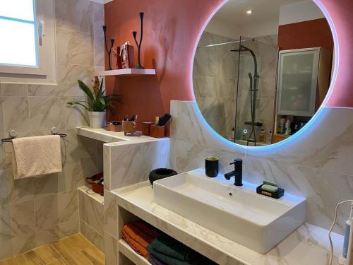 une salle de bain avec un lavabo et un miroir dans l'établissement Maison Méditerranéenne proche du cœur de ville, avec piscine, à Toulon
