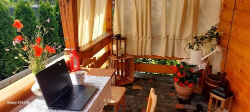 a laptop sitting on a table in a room with a window at Siedlisko pod lipą in Józefów