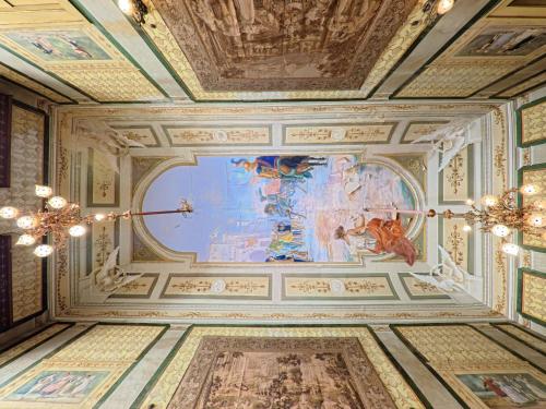 a room with paintings on the ceilings of a building at Palazzo Framarino dei Malatesta - Noble Floor - XIV Century in Giovinazzo